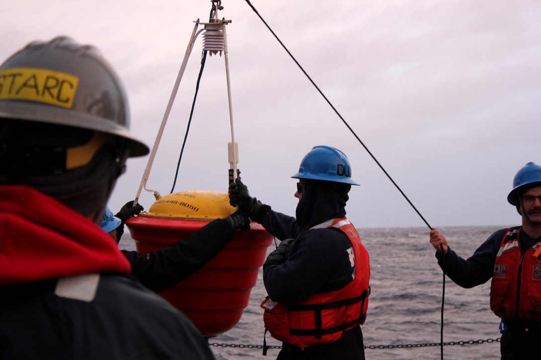 Members of U.S. Coast Guard Cutter Healy (WAGB 20) deck department and the U.S. National Science Foundation-funded Ship-based Science Technical Support in the Arctic (STARC) team deploy an air-deployable expendable ice buoy from Healy’s fantail while the cutter transits the Beaufort Sea, Oct. 21, 2024. U.S. Coast Guard photo by Lt. j.g. Haley Howard.