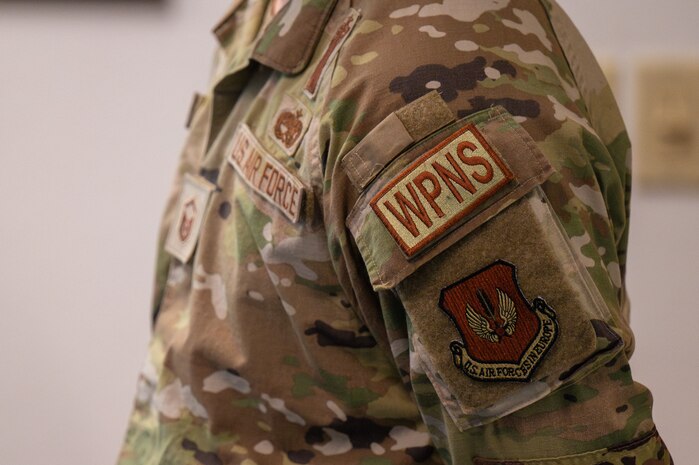 A close up of a WPNS duty identifier patch on an Airman.