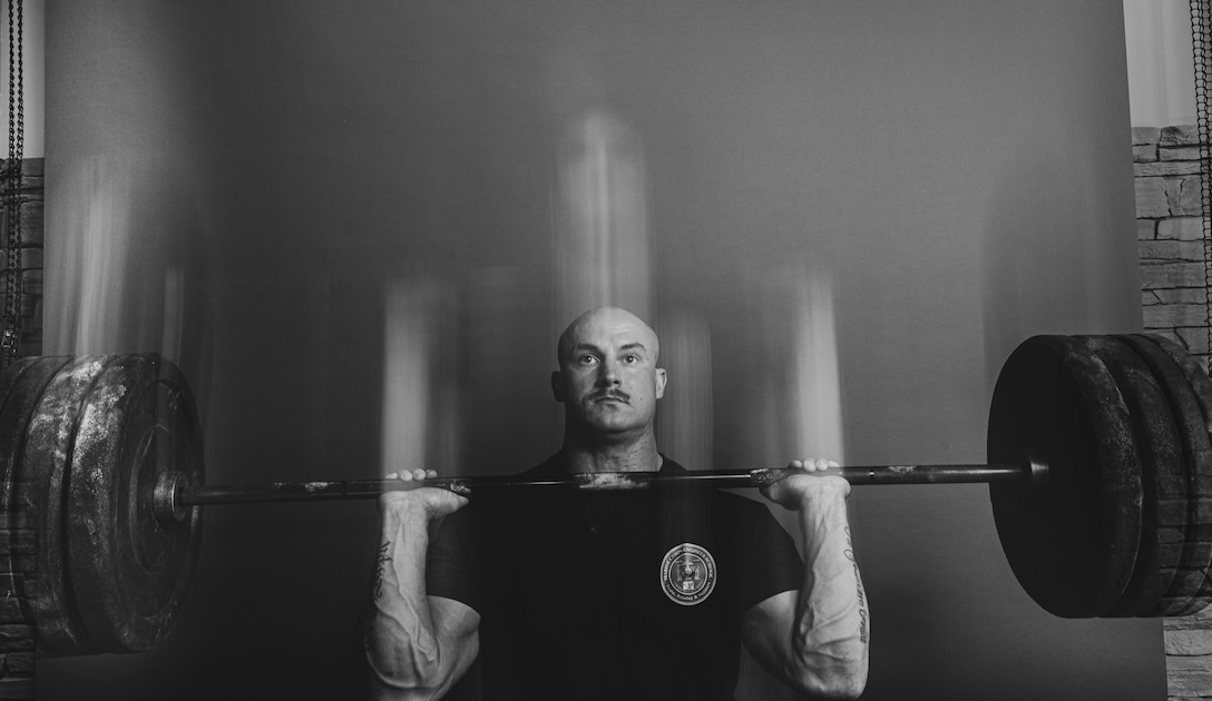 U.S. Marine Corps Staff Sgt. Geoff Laney, an instructor with Marine Corps Engineer School, Training Command, Marine Corps Base (MCB) Camp Lejeune, executes a front squat on MCB Camp Lejeune, North Carolina, Sept. 26, 2024. Laney, North Carolina's Strongest Man, has claimed victory in seven Strongman competitions, set seven world records, and competed at regional, state, and national levels across the U.S. and in Okinawa, Japan, all while passionately advocating for Marines to take an active role in their personal physical training. (U.S. Marine Corps photo by Cpl. Loriann Dauscher)