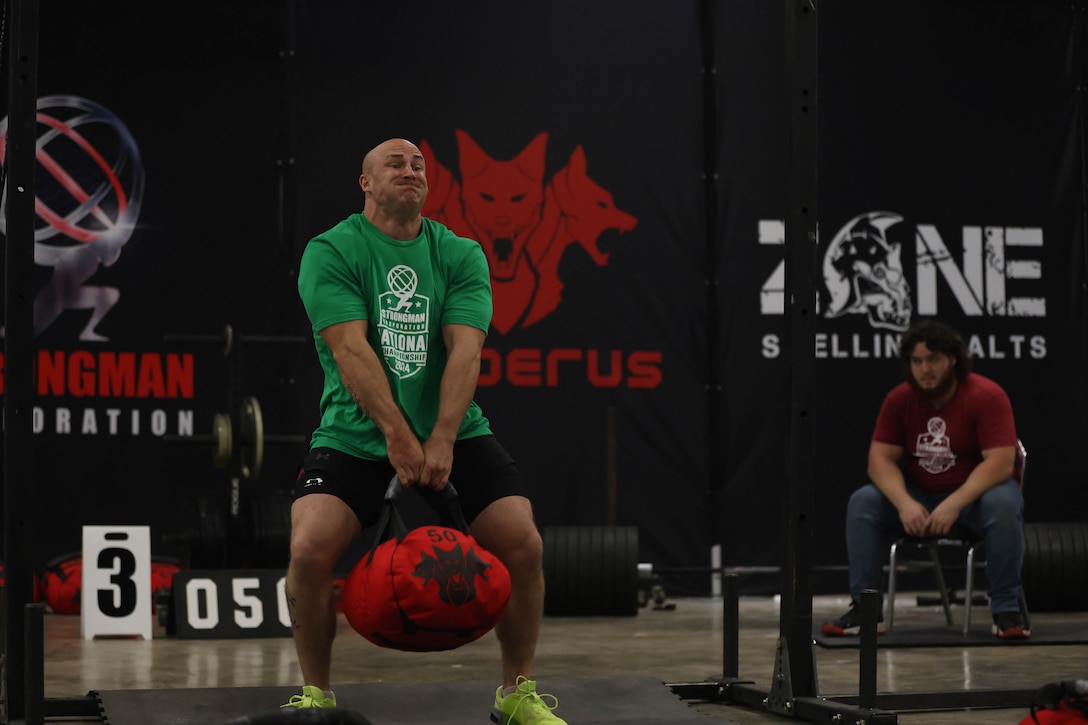U.S. Marine Corps Staff Sgt. Geoff Laney, an instructor with Marine Corps Engineer School, Training Command, on Marine Corps Base Camp Lejeune, competes in the Cerberus Bag Toss event during the 2024 Strongman Corporation National Championships in Greenville, South Carolina, Sept. 20, 2024. Laney, North Carolina's Strongest Man, has claimed victory in seven Strongman competitions, set seven world records, and competed at regional, state, and national levels across the U.S. and in Okinawa, Japan, all while passionately advocating for Marines to take an active role in their personal physical training. (U.S. Marine Corps photo by Cpl. Zeta Johnson)