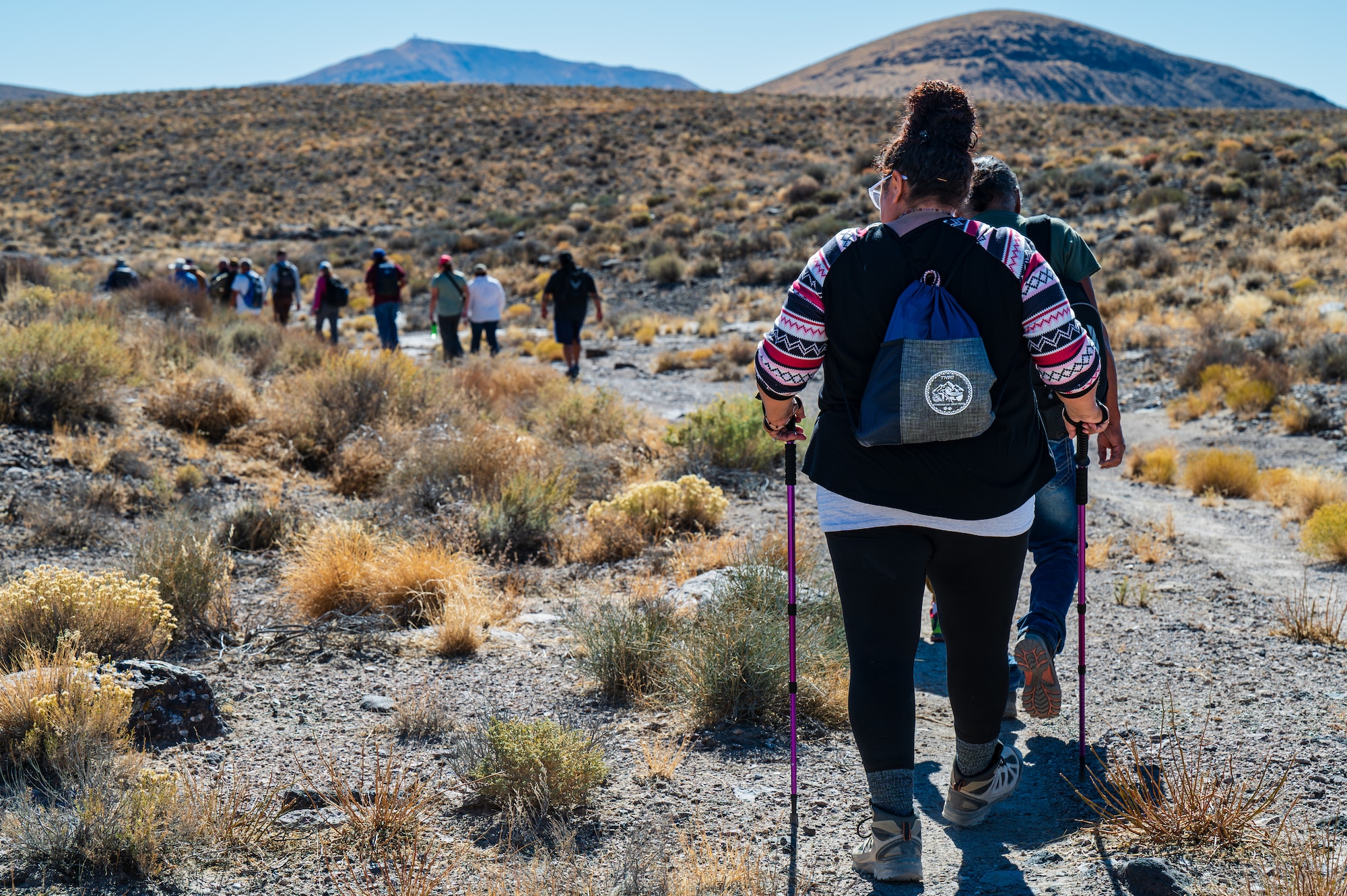 A group of people hike along a trail at the Nevada Test and Training Range.