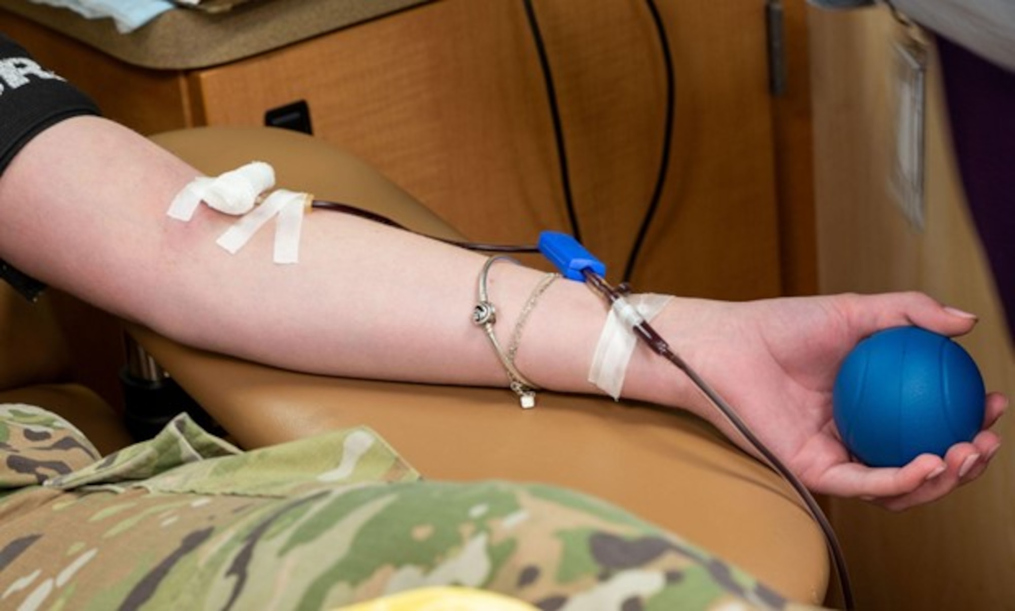 Airman holds a stress ball while donating blood. (U.S. Air Force photo by Airman Donnell Ramsey)