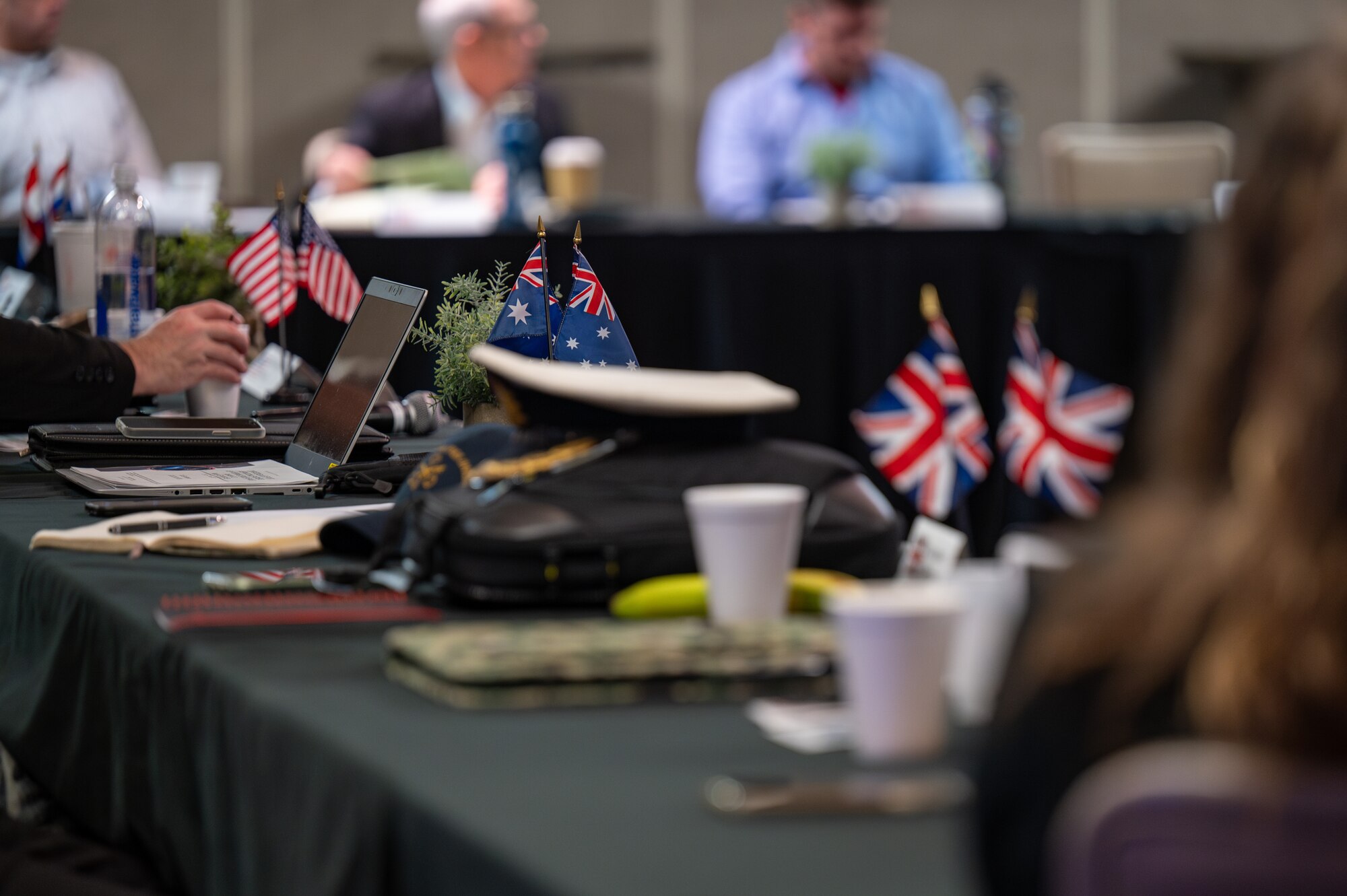 A close up of three pairs of flags sit on a table.