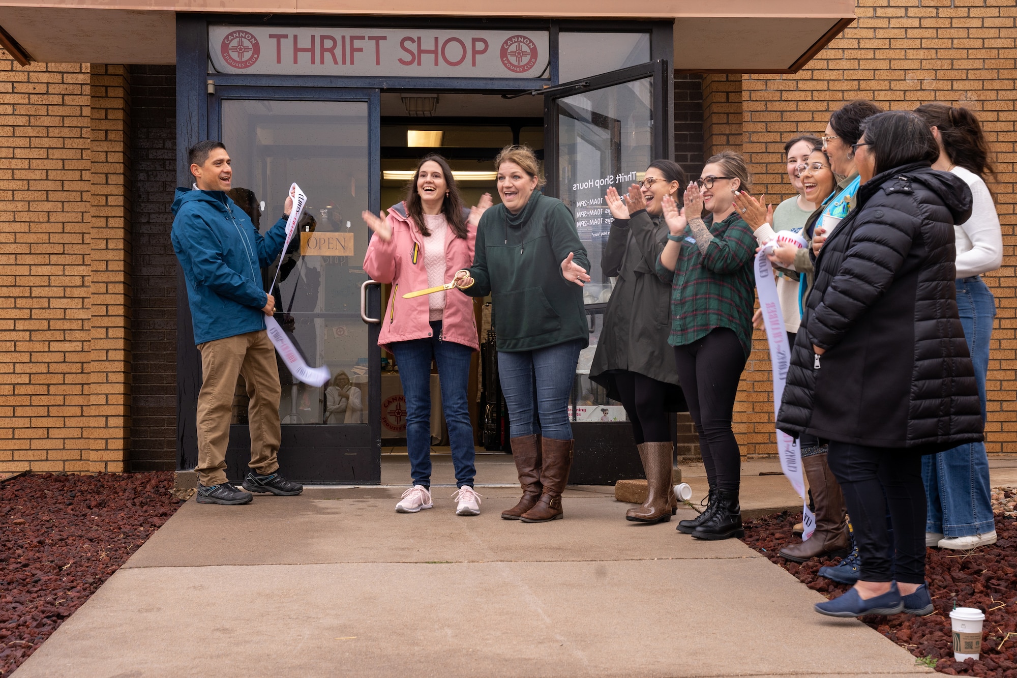 U.S. Air Force Col. Robert Johnston, 27th Special Operations Wing Commander, left, and other distinguished guests help cut the ribbon commemorating the grand re-opening of the Cannon Air Force Base Thrift Shop at Cannon AFB, New Mexico, Nov. 2, 2024.
