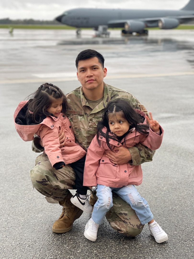 U.S. Air Force Staff Sgt. Jesse Lookingglass stands for a photograph with his daughters on April 22, 2022, before departing for a deployment to Al Udeid Air Base, Qatar.