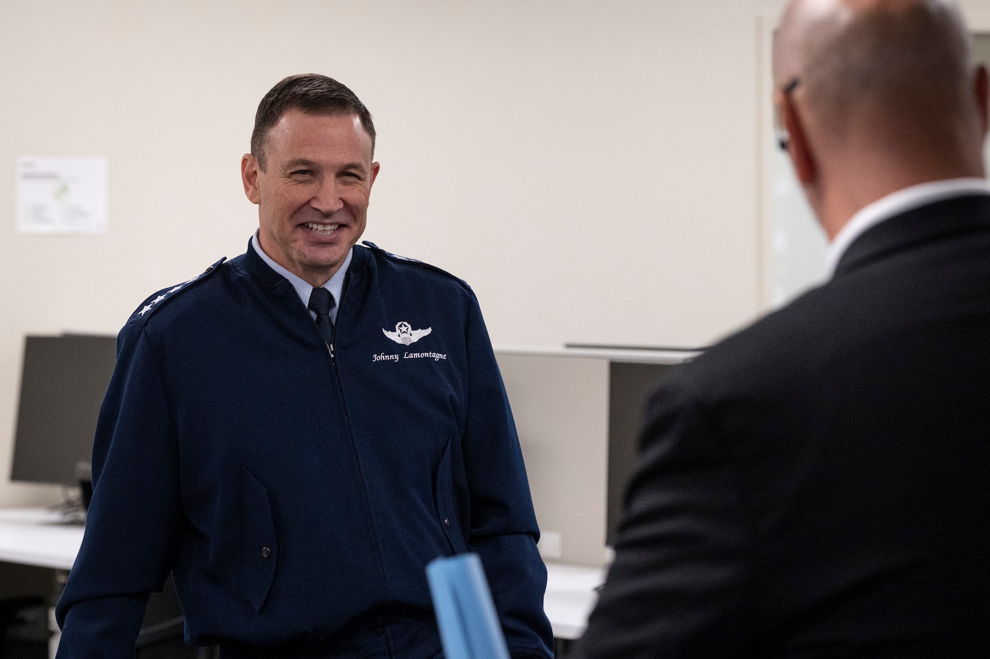 U.S. Air Force Gen. Johnny Lamontagne, Air Mobility Command commander, is briefed by Kyle Anderson, Leadership Council of Southwestern Illinois CEO, Nov. 6, 2024, at Scott Air Force Base, Illinois. The ribbon-cutting was the culmination of a collaborative effort between AMC civic leaders, Leadership Council of Southwestern Illinois and their Military Affairs Committee, Deloitte, and the Scott Spouse’s Club to bring a productive and collaborative workspace to military spouses. (U.S. Air Force photo by Staff Sgt. Dalton Williams)