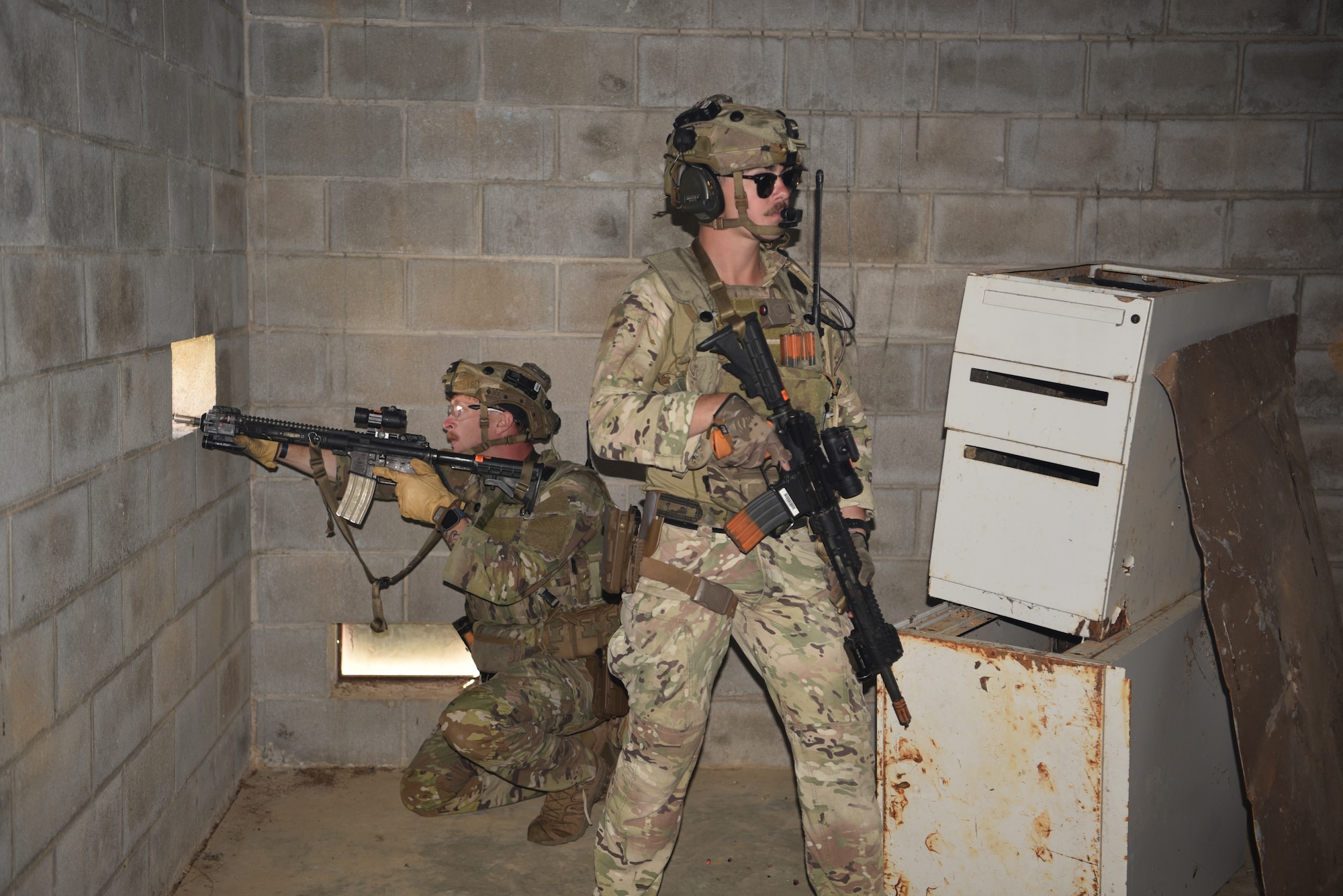 Senior Amn. Bryce Bean (right), 90 MSOS/TRF assaulter, and Senior Amn Robert Shoemake (left), 90 MSOS/CRF member, participate in an urban recovery scenario during Joint Training Exercise 2024, at Fort Chaffee, Arkansas, October 15, 2024. During the three-week JTX, Twentieth Air Force Security Forces airmen refined critical response skills alongside the U.S. Office of Secure Transportation and Royal Marines. The exercise provided hands-on experience with advanced weapons handling, live-fire drills, and urban recovery scenarios, enhancing readiness for nuclear security operations. (U.S. Air Force Photo by 1st Lt. Jacqulyn Noffsinger)