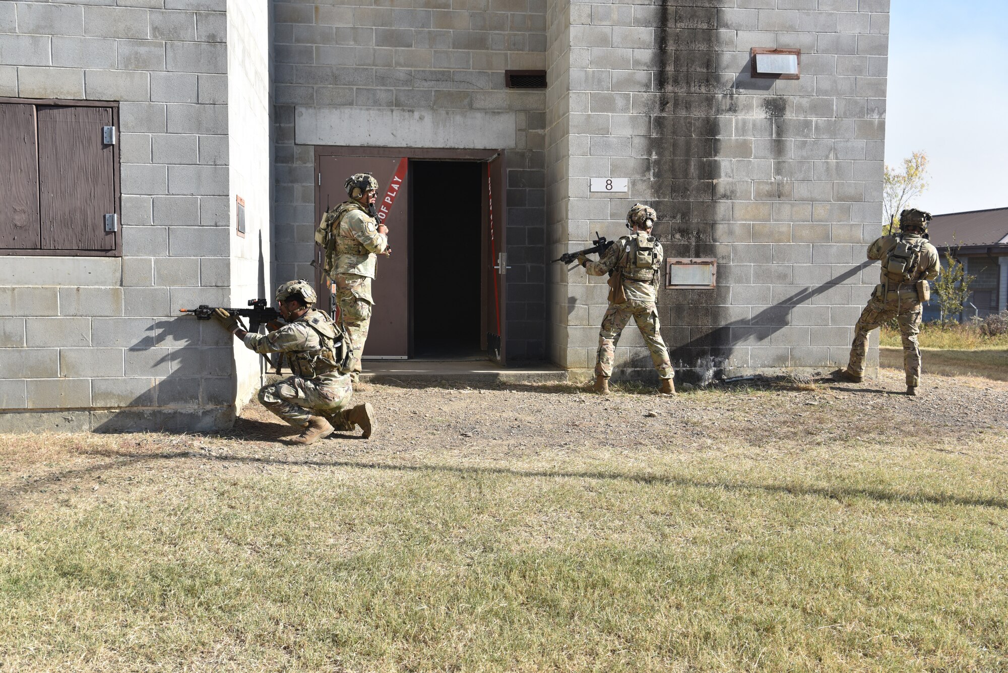 Security Forces members from across Twentieth Air Force participate in an urban recovery scenario during Joint Training Exercise 2024, at Fort Chaffee, Arkansas, October 15, 2024. During the three-week JTX, Twentieth Air Force Security Forces airmen refined critical response skills alongside the U.S. Office of Secure Transportation and Royal Marines. The exercise provided hands-on experience with advanced weapons handling, live-fire drills, and urban recovery scenarios, enhancing readiness for nuclear security operations. (U.S. Air Force Photo by 1st Lt. Jacqulyn Noffsinger)