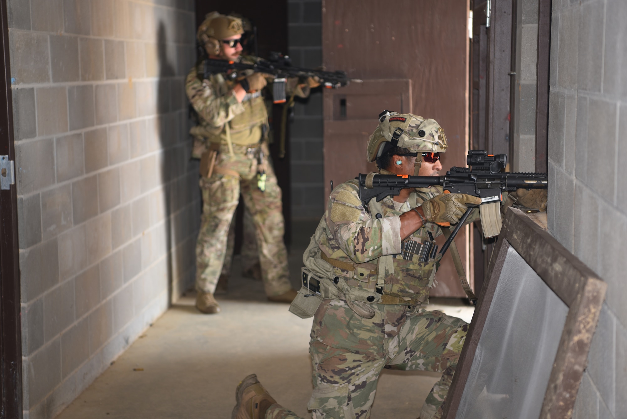 Staff Sgt. Carl Davis (right), 341 MSOS/CRF leader, and Senior Amn. Dawson Gochee (left), 90 MSOS/TRF assaulter, participate in an urban recovery scenario during Joint Training Exercise 2024, at Fort Chaffee, Arkansas, October 15, 2024. During the three-week JTX, Twentieth Air Force Security Forces airmen refined critical response skills alongside the U.S. Office of Secure Transportation and Royal Marines. The exercise provided hands-on experience with advanced weapons handling, live-fire drills, and urban recovery scenarios, enhancing readiness for nuclear security operations. (U.S. Air Force Photo by 1st Lt. Jacqulyn Noffsinger)