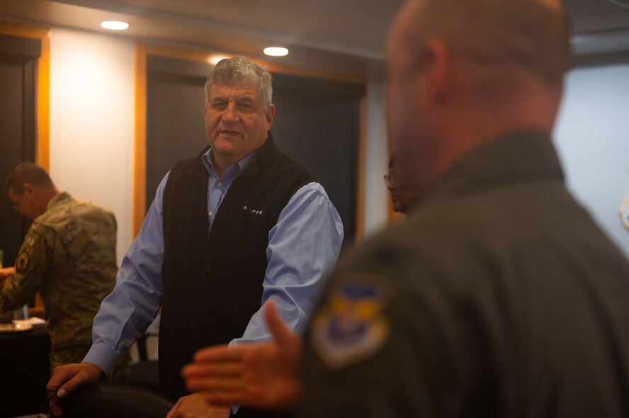 Dr. William LaPlante, Under Secretary of Defense for Acquisition and Sustainment (left), listens to Col. Benjamin Jensen, 5th Bomb Wing deputy commander, during a combined mission brief during a 5th Bomb Wing tour at Minot Air Force Base, North Dakota, Oct. 31, 2024. LaPlante’s visit underscores his commitment to advancing acquisition practices, sustaining military infrastructure and reinforcing the nation’s defense capabilities. (U.S. Air Force photo by Airman 1st Class Luis Gomez)