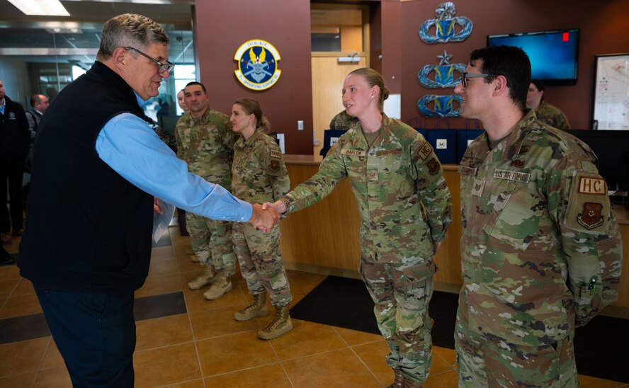 Dr. William LaPlante, Under Secretary of Defense for Acquisition and Sustainment (left), coins members of Team Minot at Minot Air Force Base, North Dakota, Oct. 31, 2024. LaPlante’s visit underscores his commitment to advancing acquisition practices, sustaining military infrastructure and reinforcing the nation’s defense capabilities. (U.S. Air Force photo by Airman 1st Class Luis Gomez)