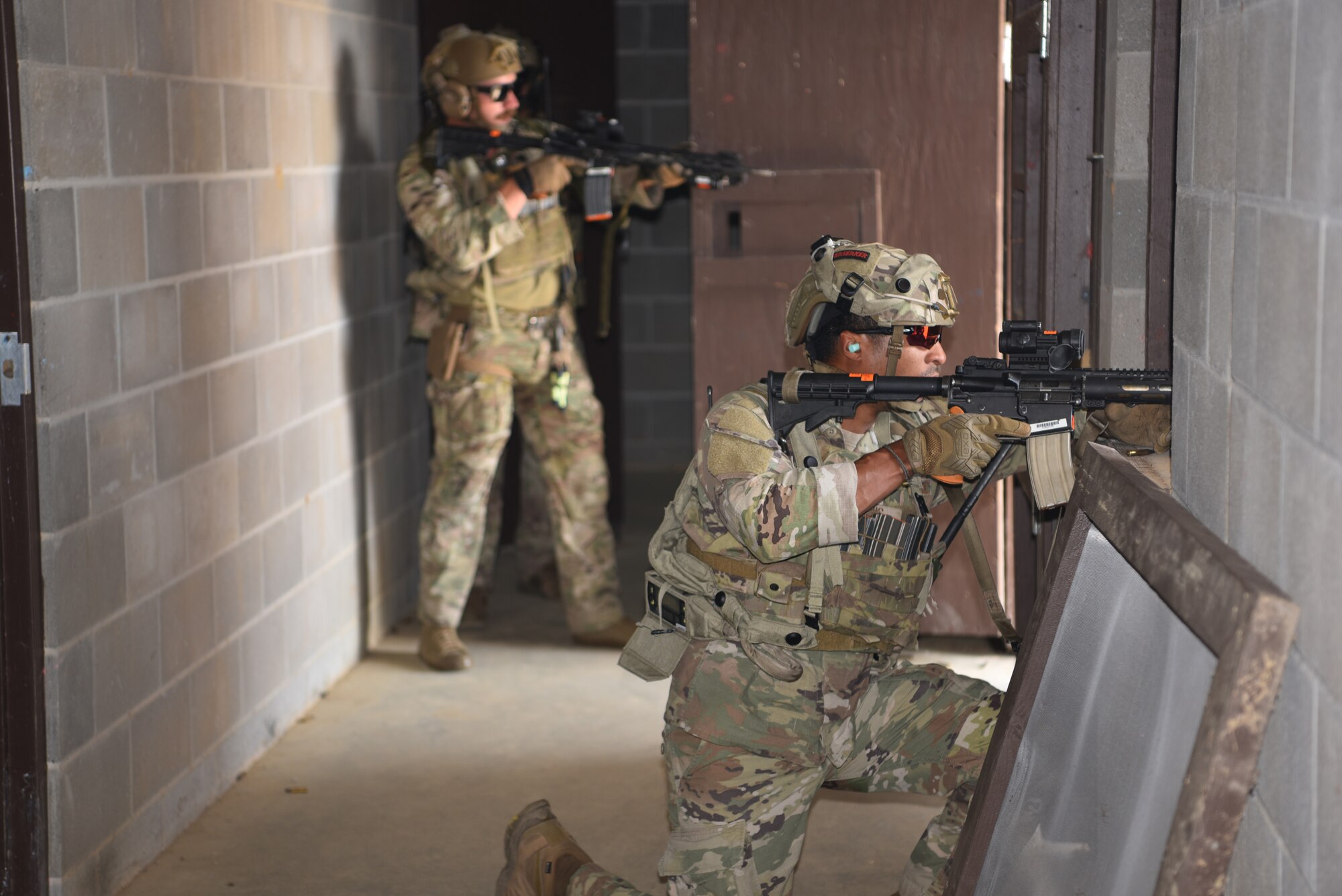 Staff Sgt. Carl Davis (right), 341 MSOS/CRF leader, and Senior Amn. Dawson Gochee (left), 90 MSOS/TRF assaulter, participate in an urban recovery scenario during Joint Training Exercise 2024, at Fort Chaffee, Arkansas, October 15, 2024. During the three-week JTX, Twentieth Air Force Security Forces airmen refined critical response skills alongside the U.S. Office of Secure Transportation and Royal Marines. The exercise provided hands-on experience with advanced weapons handling, live-fire drills, and urban recovery scenarios, enhancing readiness for nuclear security operations. (U.S. Air Force Photo by 1st Lt. Jacqulyn Noffsinger)