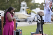 Cordelia Bell, wife of Staff Sgt. Dante Bell, takes a moment in front of Bell’s battle cross during a unit memorial ceremony for Bell who died last month in a training incident.