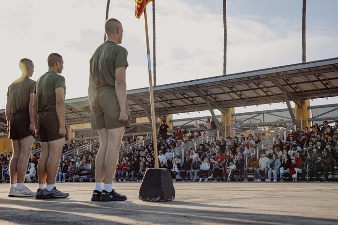 The family and friends of the new U.S. Marines with Delta Company, 1st Recruit Training Battalion, observe their Marines conduct dynamic warm-ups prior to the motivational run at Marine Corps Recruit Depot San Diego, California, Oct. 31, 2024. The company motivational run is a three-mile cadence run conducted around the Depot and is the last physical training event the Marines will conduct before the graduate from MCRD San Diego. The event is also the first time friends and families will see their newly transformed Marines. (U.S. Marine Corps photo by Cpl. Sarah M. Grawcock)