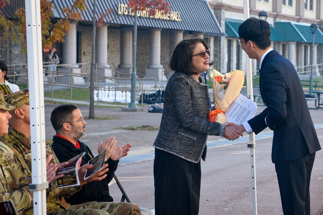 Chi Wan Ham, Army Military Pay Office Korea in- and out-processing military pay technician, presents flowers to Mary Jelev, U.S. Army Financial Management Command Military Pay Operations director, during the AMPO’s ribbon cutting ceremony at Camp Humphreys, South Korea, Oct. 31, 2024. USAFMCOM opened the new AMPO on Camp Humphreys as well as two satellite locations at Camps Walker and Casey. (U.S. Army photo by Cpl. Kianna Scott)