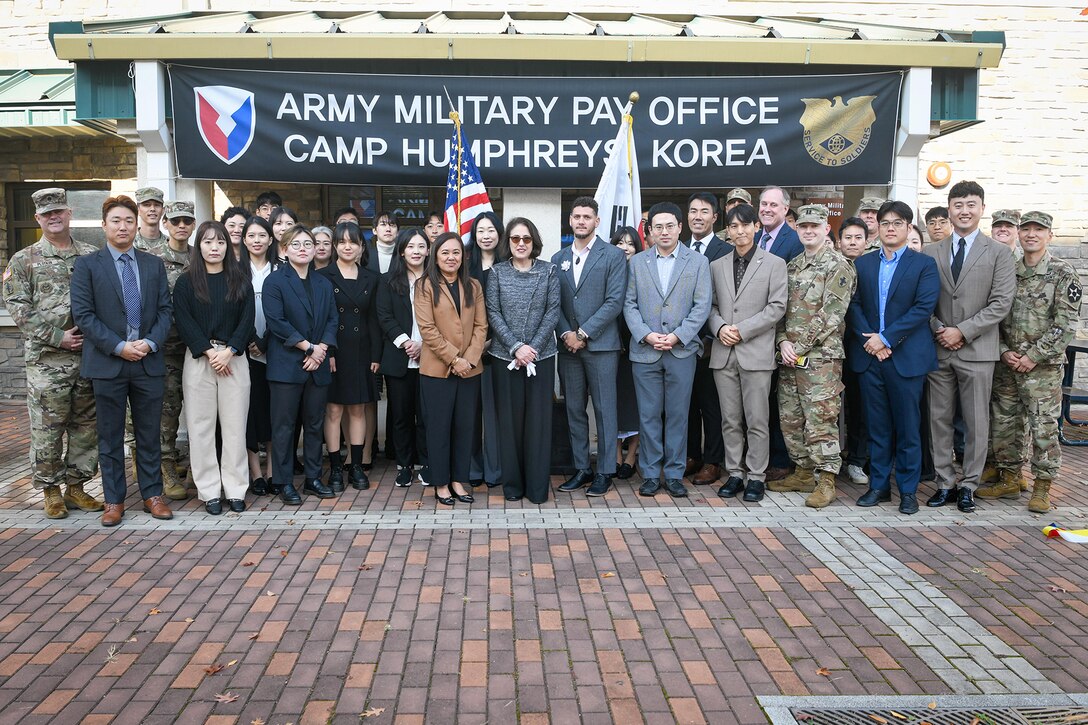 A group of U.S. Army Soldiers, civilian employees and Korean Service Corps Battalion personnel gather during a special ribbon-cutting ceremony opening AMPO Korea at Camp Humphreys, South Korea, Oct. 31, 2024. USAFMCOM opened the new AMPO on Camp Humphreys as well as two satellite locations at Camps Walker and Casey. (U.S. Army photo by Cpl. Kianna Scott)
