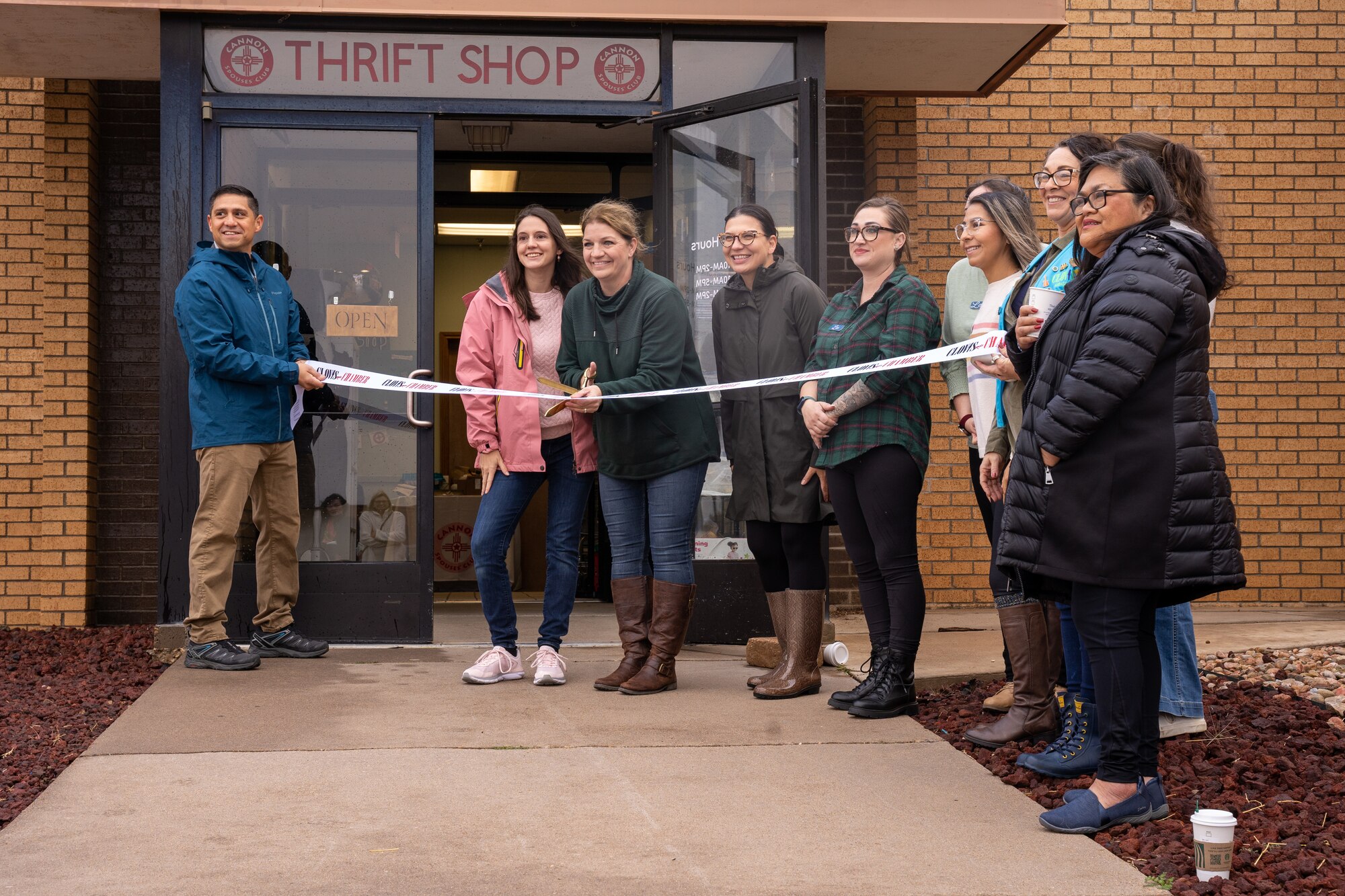 U.S. Air Force Col. Robert Johnston, 27th Special Operations Wing Commander, left, and other distinguished guests help cut the ribbon commemorating the grand re-opening of the Cannon Air Force Base Thrift Shop at Cannon AFB, New Mexico, Nov. 2, 2024.