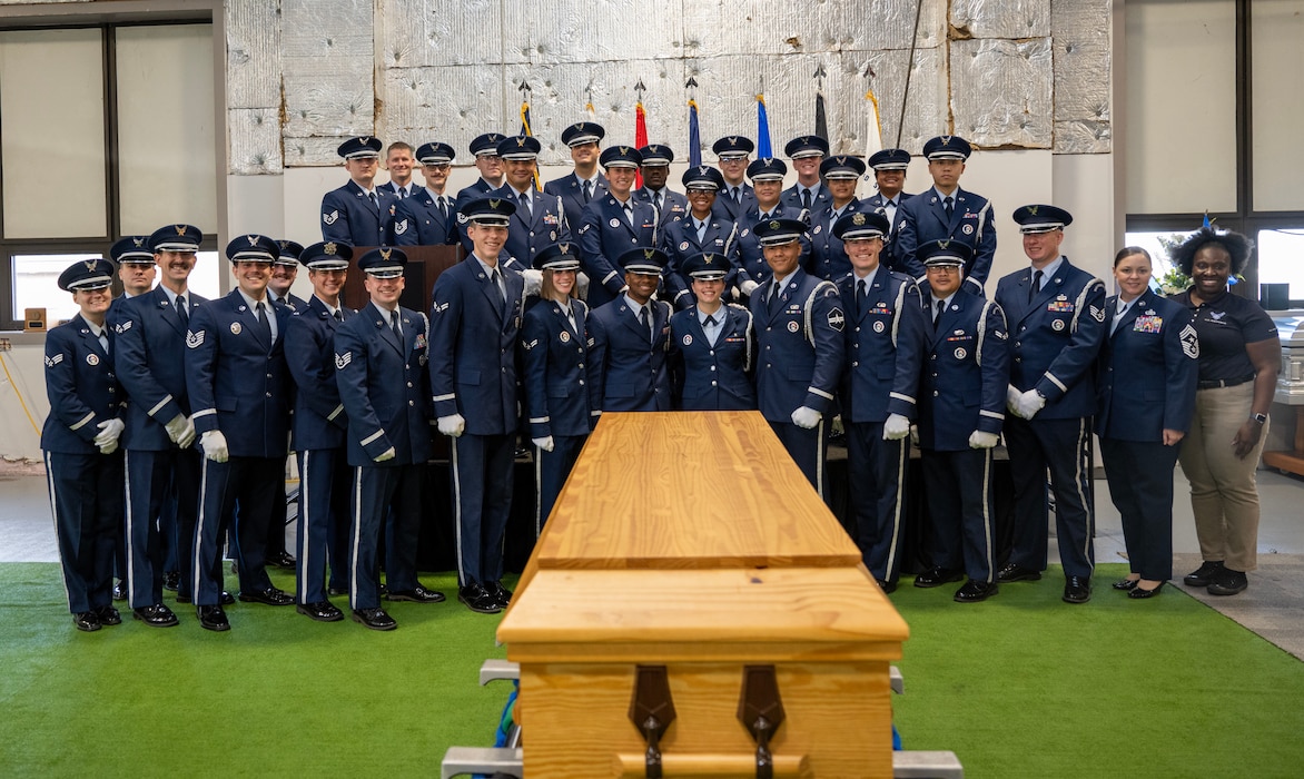 Base honor guard graduates pose for a group photo during a graduation ceremony at Wright-Patterson Air Force Base, Ohio, Oct. 30, 2024. The WPAFB Honor Guard provides military funeral honors for fallen veterans, retirees and active-duty service members and presents the colors for eligible retirement, promotion ceremonies and special events. (U.S. Air Force photo by Jack Gardner)