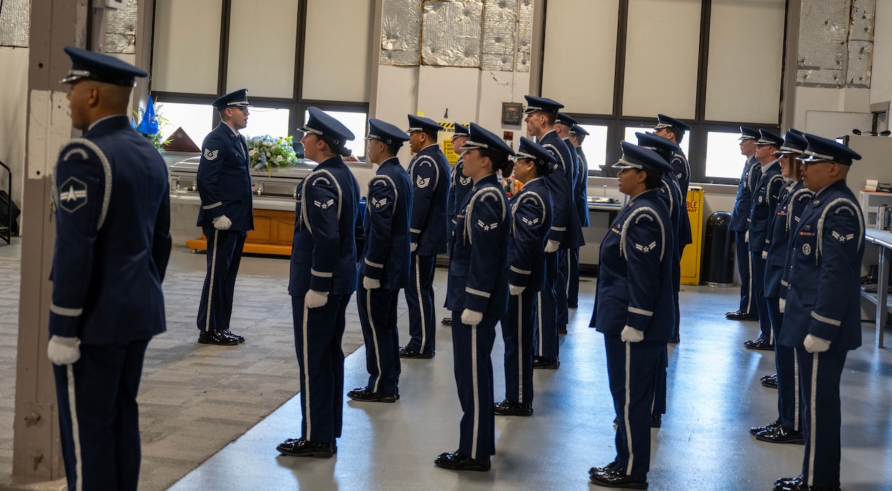 Base honor guard graduates stand in formation to receive their graduation certificates during a ceremony at Wright-Patterson Air Force Base, Ohio, Oct. 30, 2024. The WPAFB Honor Guard provides military funeral honors for fallen veterans, retirees and active-duty service members and presents the colors for eligible retirement, promotion ceremonies and special events. (U.S. Air Force photo by Jack Gardner)