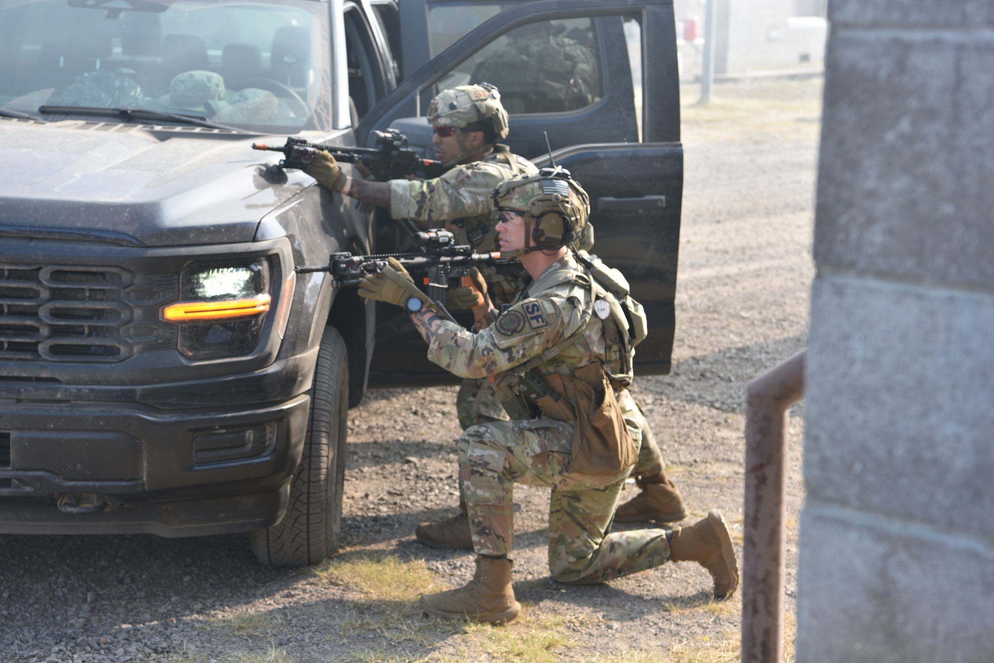 Master Sgt. Jered Dauterman (near), 341 MSOS/TRF flight chief, and Staff Sgt. Carl Davis (far), 341 MSOS/CRF leader, participate in an urban recovery scenario during Joint Training Exercise 2024, at Fort Chaffee, Arkansas, October 15, 2024. During the three-week JTX, Twentieth Air Force Security Forces airmen refined critical response skills alongside the U.S. Office of Secure Transportation and Royal Marines. The exercise provided hands-on experience with advanced weapons handling, live-fire drills, and urban recovery scenarios, enhancing readiness for nuclear security operations. (U.S. Air Force Photo by 1st Lt. Jacqulyn Noffsinger)