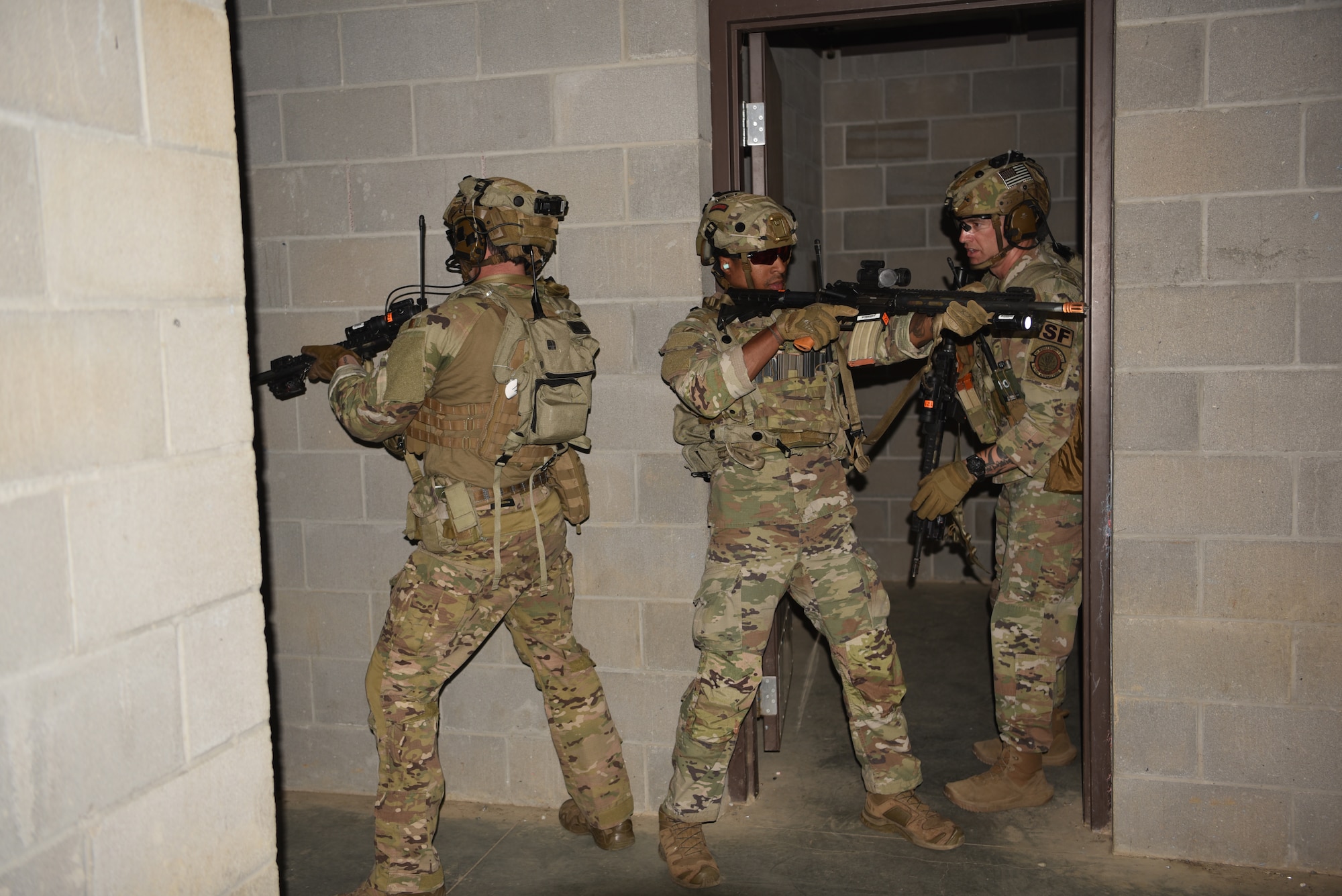 Staff Sgt. Jahd Awaida (left), 341 MSOS/TRF assaulter, Staff Sgt. Carl Davis (center), 341 MSOS/CRF leader, and Master Sgt. Jered Dauterman (left), 341 MSOS/TRF flight chief, participate in an urban recovery scenario during Joint Training Exercise 2024, at Fort Chaffee, Arkansas, October 15, 2024. During the three-week JTX, Twentieth Air Force Security Forces airmen refined critical response skills alongside the U.S. Office of Secure Transportation and Royal Marines. The exercise provided hands-on experience with advanced weapons handling, live-fire drills, and urban recovery scenarios, enhancing readiness for nuclear security operations. (U.S. Air Force Photo by 1st Lt. Jacqulyn Noffsinger)