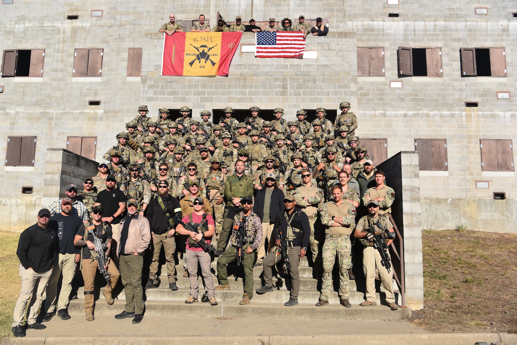 Security Forces members from across Twentieth Air Force pose for a photograph alongside members of the U.S. Office of Secure Transportation and Royal Marines during Joint Training Exercise 2024, at Fort Chaffee, Arkansas, October 15, 2024. During the three-week JTX, Twentieth Air Force Security Forces airmen refined critical response skills alongside the U.S. Office of Secure Transportation and Royal Marines. The exercise provided hands-on experience with advanced weapons handling, live-fire drills, and urban recovery scenarios, enhancing readiness for nuclear security operations. (U.S. Air Force Photo by 1st Lt. Jacqulyn Noffsinger)