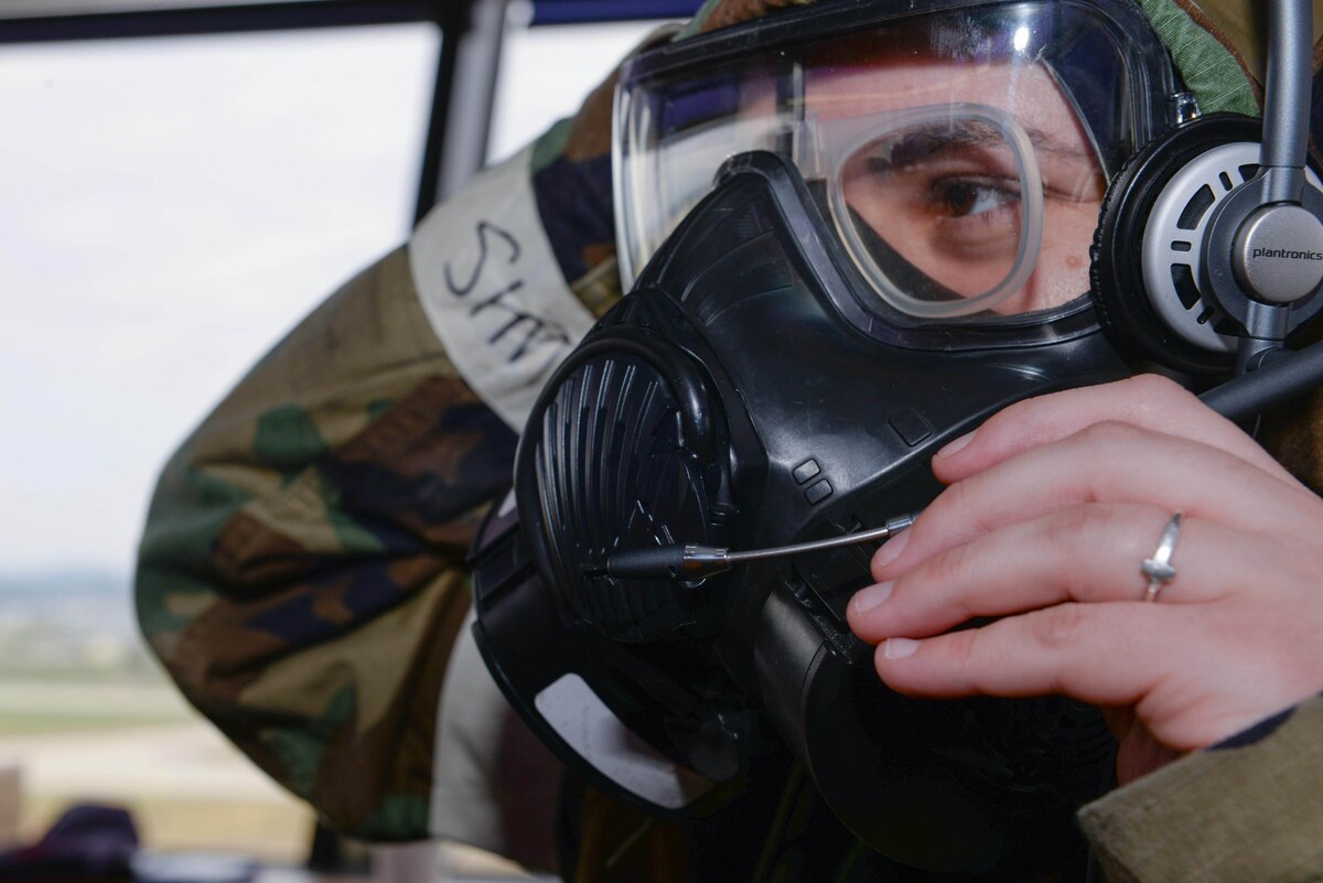 U.S. Air Force Senior Airman Loren Wightman, 51st Operations Support Squadron air traffic controller, dons a speakerphone atop her M-50 gas mask during Beverly Herd 25-1 at Osan Air Base, Republic of Korea, Oct. 29, 2024. Air traffic controllers at the 51st Fighter Wing are working with industry experts to find an innovative high tech solution to transmit their air-to-ground and ground-to-air communications during live air traffic operations. (U.S. Air Force photo by Staff Sgt. Kahdija Slaughter)