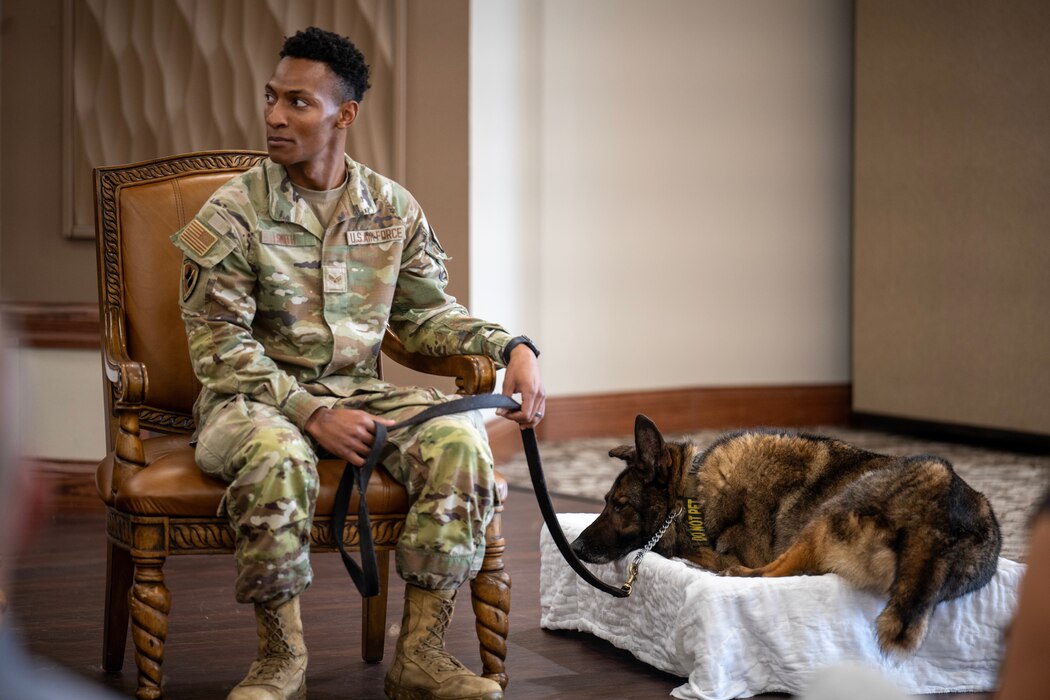Senior Airman Benjamin Smith, 88th Security Forces Squadron military working dog handler, and MWD Kerry are honored during Kerry’s retirement ceremony at Wright-Patterson Air Force Base, Ohio, on Nov. 4, 2024. Such ceremonies recognize the loyalty and bravery of military working dogs, marking the end of their careers and the start of a well-earned rest. (U.S. Air Force photo by Jack Gardner)
