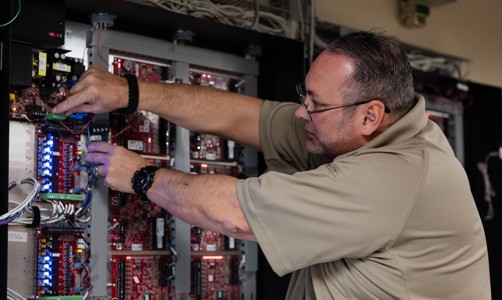 A man fixes wires.