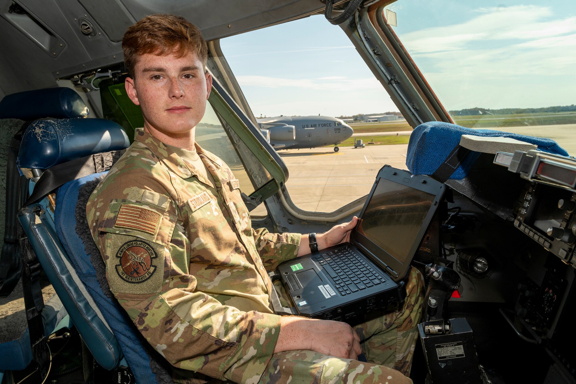 a man sits in the pilot seat of an aircraft