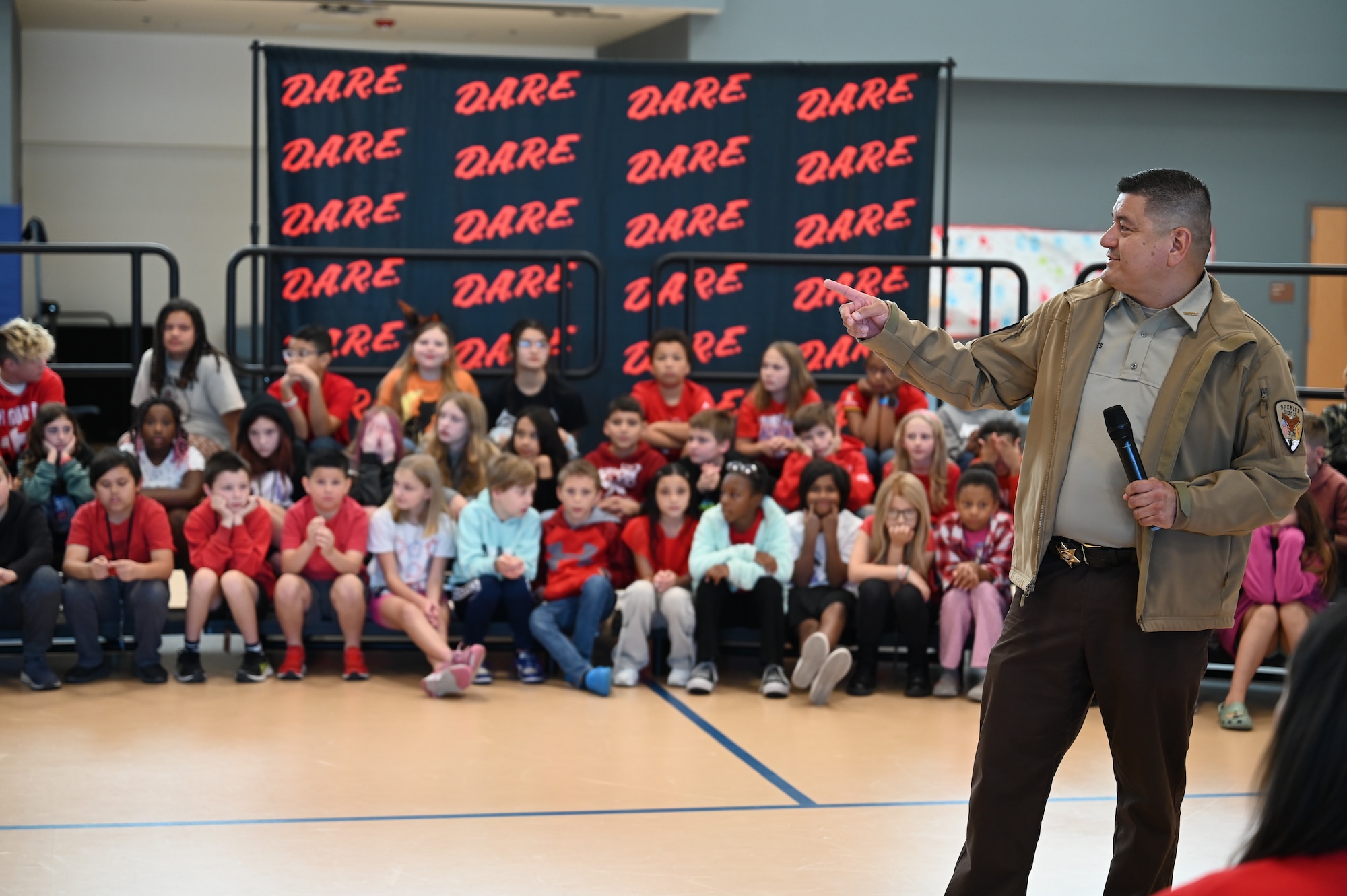 Raul Robles, Otero County public relations deputy sheriff, conducts a Drug Abuse Resistance Education presentation at Holloman Air Force Base, New Mexico, Oct. 31, 2024. The D.A.R.E. program is a well-designed multicultural curriculum that aligns with developmental needs and equips young people with essential skills to ensure they lead safe, healthy, and responsible lives, free from substance abuse. (U.S. Air Force photo by Airman 1st Class Michelle Ferrari)