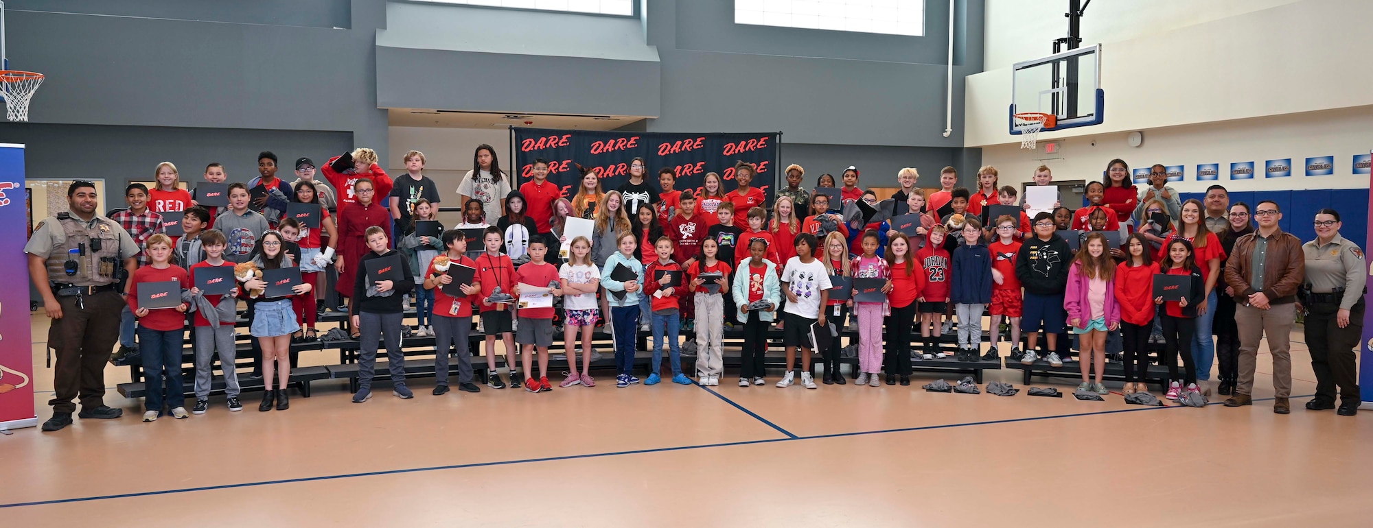 Holloman Elementary students participate in a Drug Abuse Resistance Education graduation ceremony at Holloman Air Force Base, New Mexico, Oct. 31, 2024. The D.A.R.E. program provides an engaging 10-week curriculum by focusing on a culturally diverse curriculum that is suitable for various developmental stages by empowering youth with the foundational abilities necessary to navigate life safely and make responsible choices, promoting a drug-free lifestyle. (U.S. Air Force photo by Airman 1st Class Michelle Ferrari)
