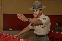 U.S. Marine Corps Staff Sgt. Joshua Brown, a drill instructor with Receiving Company, Support Battalion, instructs recruits during the Bravo Company, 1st Recruit Training Battalion, receiving event at Marine Corps Recruit Depot San Diego, California, Oct. 28, 2024. During the receiving process, recruits are taken to the United States Organizations for accountability, checked for contraband, given haircuts, make scripted phone calls home, and issued gear required for training. (U.S. Marine Corps photo by Cpl. Sarah M. Grawcock)