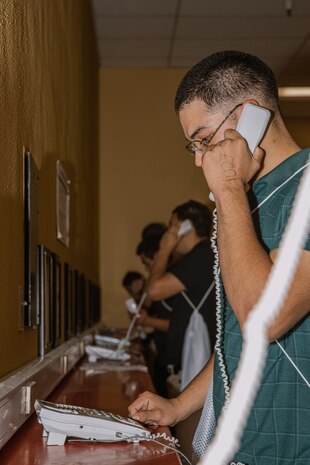 U.S. Marine Corps recruits with Bravo Company, 1st Recruit Training Battalion, make a scripted phone call home as part of a receiving event at Marine Corps Recruit Depot San Diego, California, Oct. 28, 2024. During the receiving process, recruits are taken to the United States Organizations for accountability, checked for contraband, given haircuts, make scripted phone calls home, and issued gear required for training. (U.S. Marine Corps photo by Cpl. Sarah M. Grawcock)