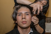 A U.S. Marine Corps recruit with Bravo Company, 1st Recruit Training Battalion, receives a haircut during a receiving event at Marine Corps Recruit Depot San Diego, California, Oct. 28, 2024. During the receiving process, recruits are taken to the United States Organizations for accountability, checked for contraband, given haircuts, make scripted phone calls home, and issued gear required for training. (U.S. Marine Corps photo by Cpl. Sarah M. Grawcock)