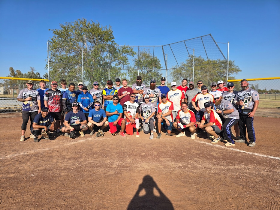 Airmen from Altus Air Force Base and Fort Sill Soldiers pose for a photo following an Armed Services Softball Championships game at Altus, Oklahoma, Oct. 12, 2024. The championship included three teams, the “Oklahoma Guzzlers,” Airmen and Soldiers both active duty and retired, the “Homeplate Heroes,” Airmen from the 97th Mission Support Group, and the “Rat Pack,” Airmen from the 58th Airlift Squadron. (courtesy photo)