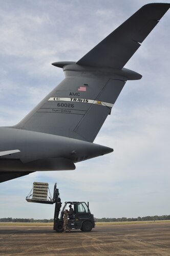 people load cargo onto an aircraft