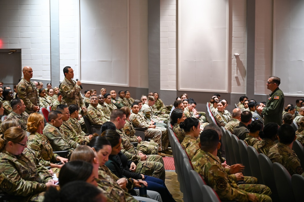 Col. Douglas C. Jeffrey, IV, 433rd Airlift Wing commander, listens as a Reserve Citizen Airmen asks a question during the wing stand-up meeting at the Bob Hope Theatre at Joint Base San Antonio-Lackland, Texas Nov. 2, 2024.