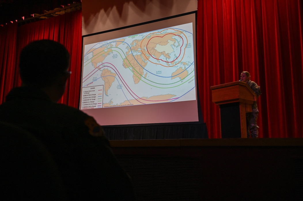 Tech. Sgt. Brittany Tesney, 433rd Airlift Wing Intelligence Non-Commissioned Officer In Charge, performs an unclassified intel brief during a wing stand-up meeting at the Bob Hope Theatre at Joint Base San Antonio-Lackland, Texas Nov. 2, 2024.