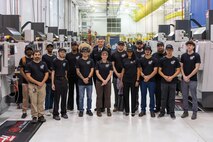 WARREN, Mich. – Rear Adm. Pete Small, Naval Sea Systems Command deputy commander for naval systems engineering, poses for a photo with incoming students of Macomb Community College's Maritime Manufacturing Accelerated Training Industry Partnership program. During today's launch event, Small delivered the keynote address and toured the college's Michigan Technical Education Center (M-TEC). The first 16-week cohort, beginning classes on November 12, includes 24 students split evenly between welding and CNC machining programs, with two veterans among the inaugural class.