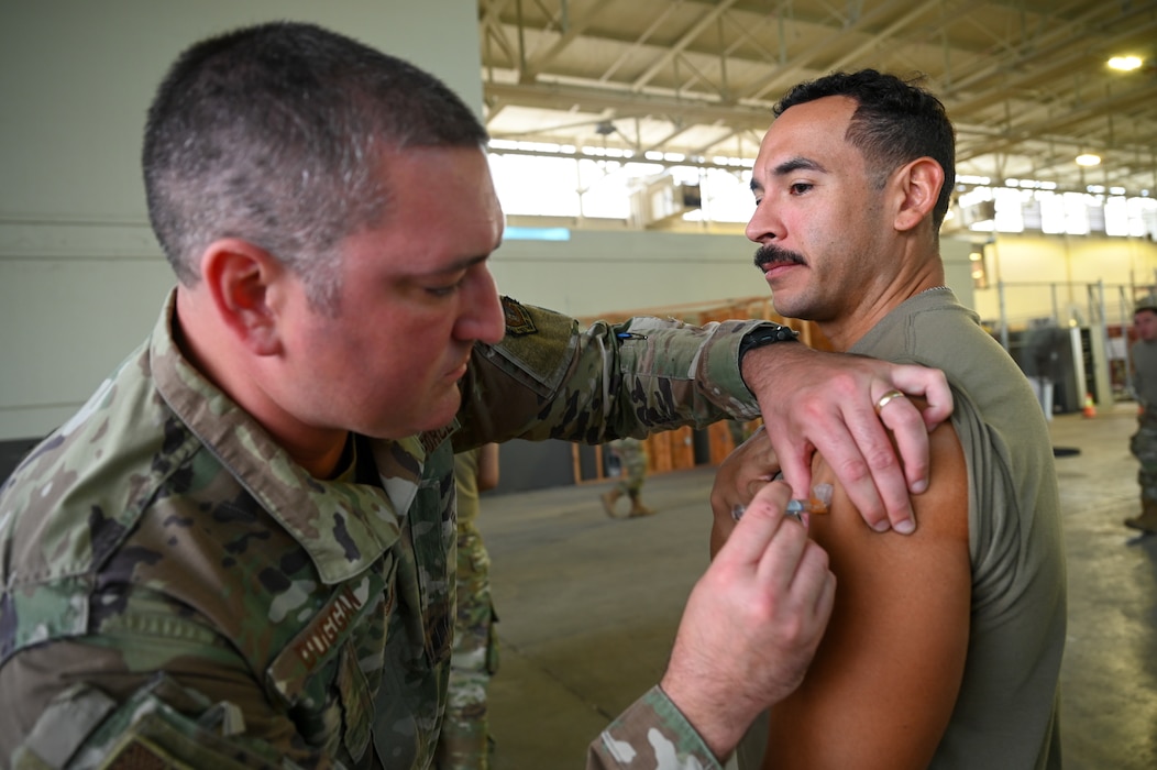 Tech. Sgt. David Duggan, a 433rd Medical Squadron medical technician, administers an annual flu vaccine to Staff Sgt. Virgil Salidavar, a 433rd Contingency Response Flight specialist, at a clinic on Joint Base San Antonio-Lackland, Texas, on Nov. 2, 2024.