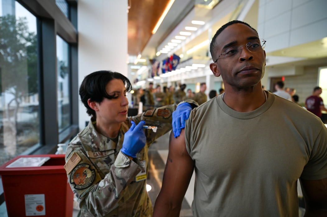 Staff Sgt. Amanda Gamez, a 433rd Aerospace Medicine Squadron flight medicine technician, administers an annual flu vaccine to a 433rd Airlift Wing Reserve Citizen Airman as part of a clinic inside Wilford Hall Ambulatory Surgical Center at Joint Base San Antonio-Lackland, Texas, on Nov. 3, 2024.