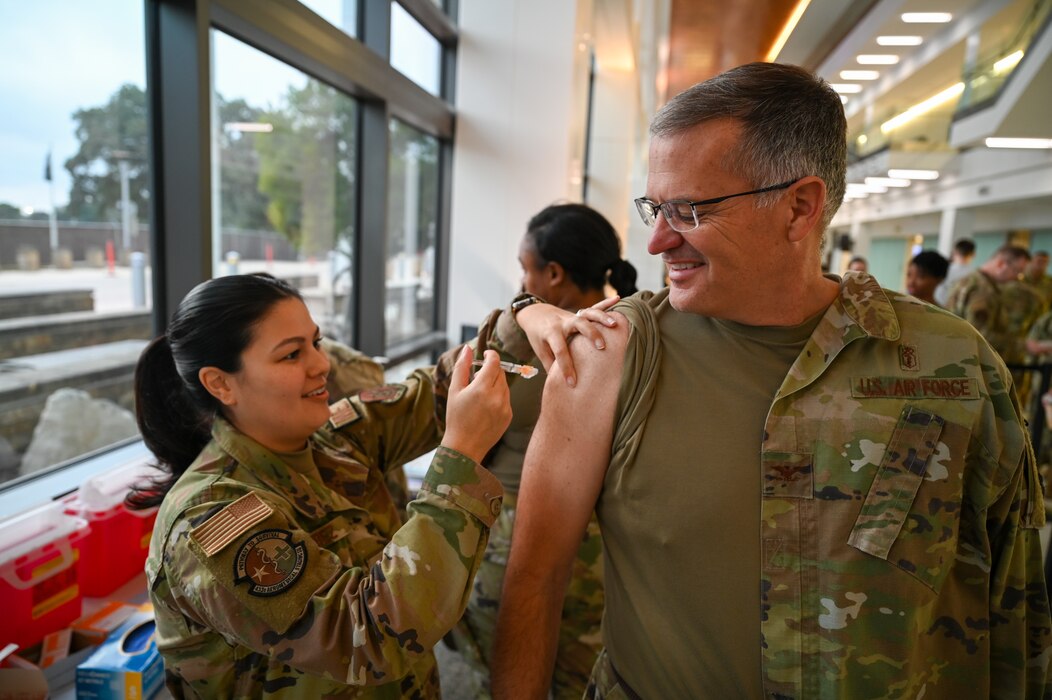 Tech. Sgt. Demi Ramirez, a 433rd Aeromedical Staging Squadron medical technician, administers the annual flu vaccine to Col. James M. Bershinsky, 433rd Medical Group commander, at a clinic inside Wilford Hall Ambulatory Surgical Center here at Joint Base San Antonio-Lackland, Texas, on Nov. 3, 2024.