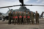 U.S. Marines with Marine Medium Tiltrotor Squadron 262 (Rein.), 31st Marine Expeditionary Unit, pose for a photo next to an UH-1Y Venom helicopter during an award ceremony on Marine Corps Air Station Futenma, Okinawa, Japan, Nov. 6, 2024. On October 12, 2024, the Marines assisted in saving the life of a local woman who had been swept away by strong currents near Cape Zanpa, Okinawa, Japan. The decisive actions carried out by the Marines that day not only saved a life, but demonstrated the Marines’ commitment to the local community, even when off-duty. (U.S. Marine Corps photo by Cpl. Angel Diaz Montes De Oca)