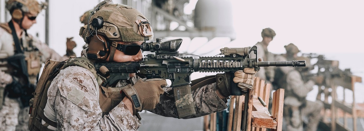 A U.S. Marine assigned to Reconnaissance Company, 15th Marine Expeditionary Unit, fires an M4 carbine during a live-fire exercise aboard the amphibious assault ship USS Boxer (LHD 4) in the Pacific Ocean, Oct. 4, 2024.