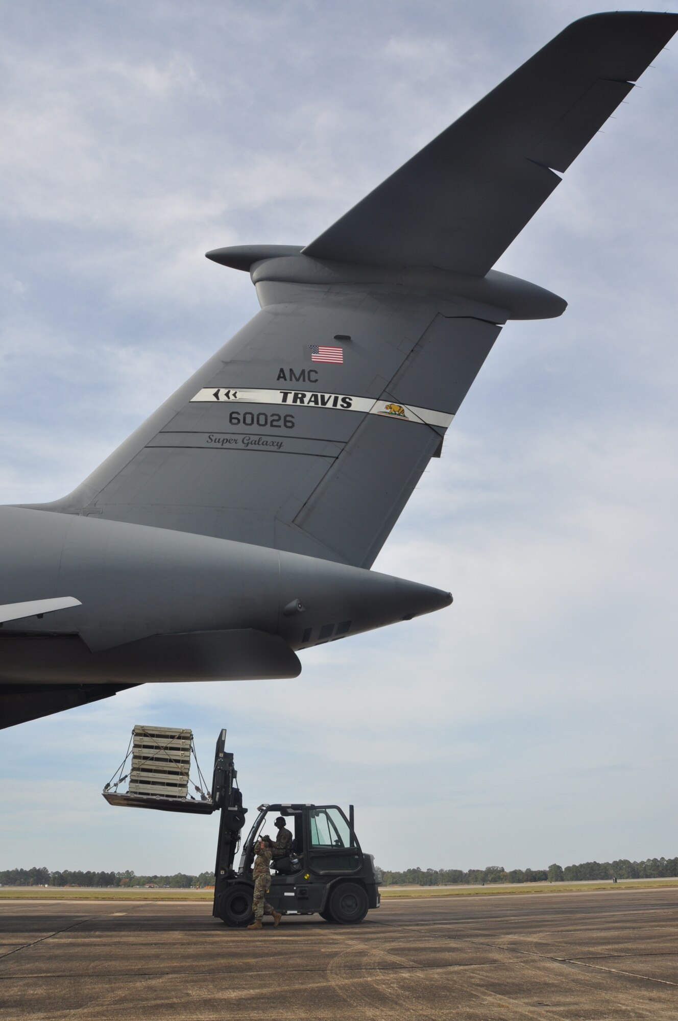 people load cargo onto an aircraft