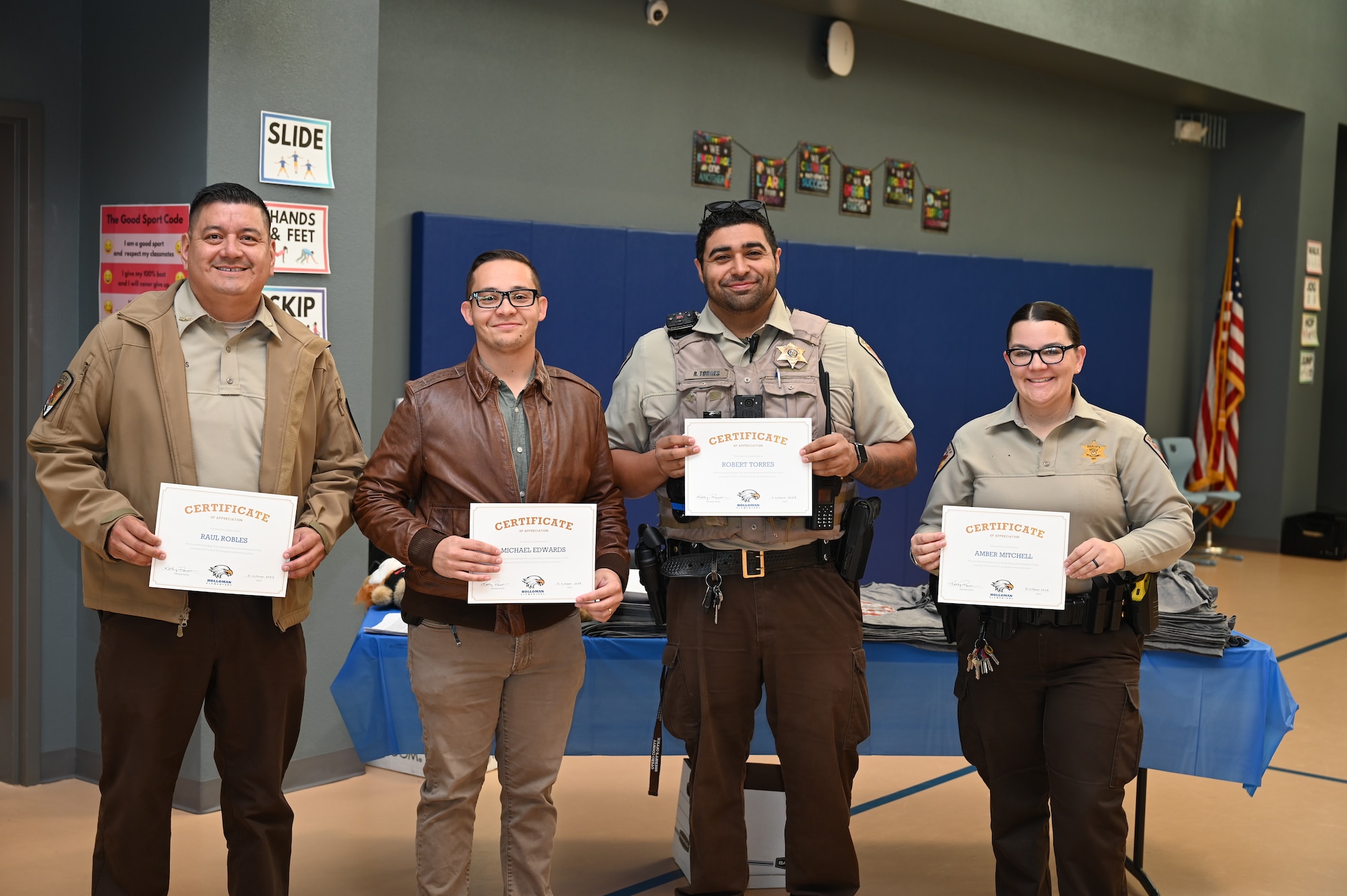 Otero County Sheriff’s team received certificates of appreciation from Holloman Elementary School at Holloman Air Force Base, New Mexico, Oct. 31, 2024. The D.A.R.E. program provides an engaging 10-week curriculum by focusing on a culturally diverse curriculum that is suitable for various developmental stages by empowering youth with the foundational abilities necessary to navigate life safely and make responsible choices, promoting a drug-free lifestyle. (U.S. Air Force photo by Airman 1st Class Michelle Ferrari)