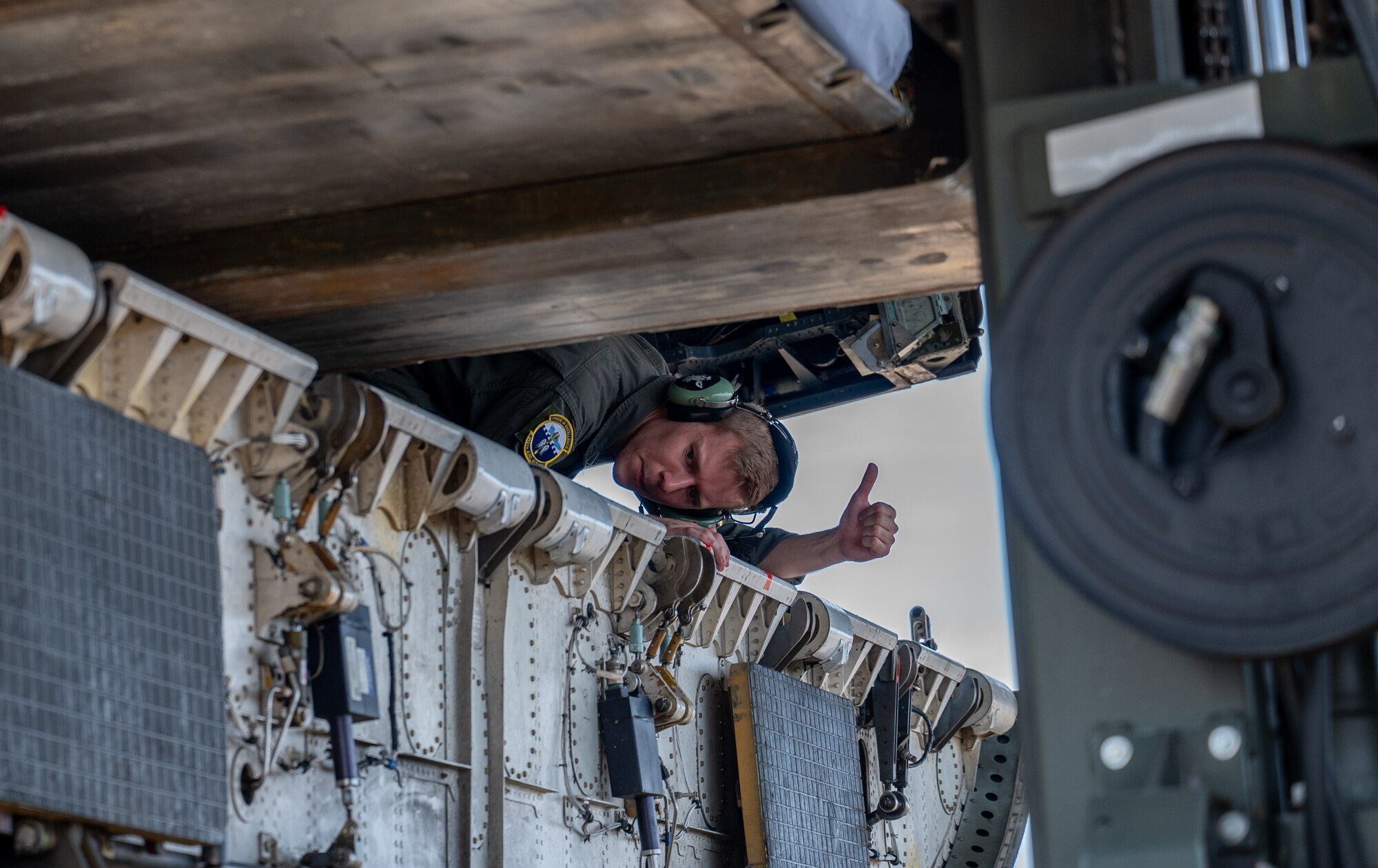 a person loads equipment on an aircraft