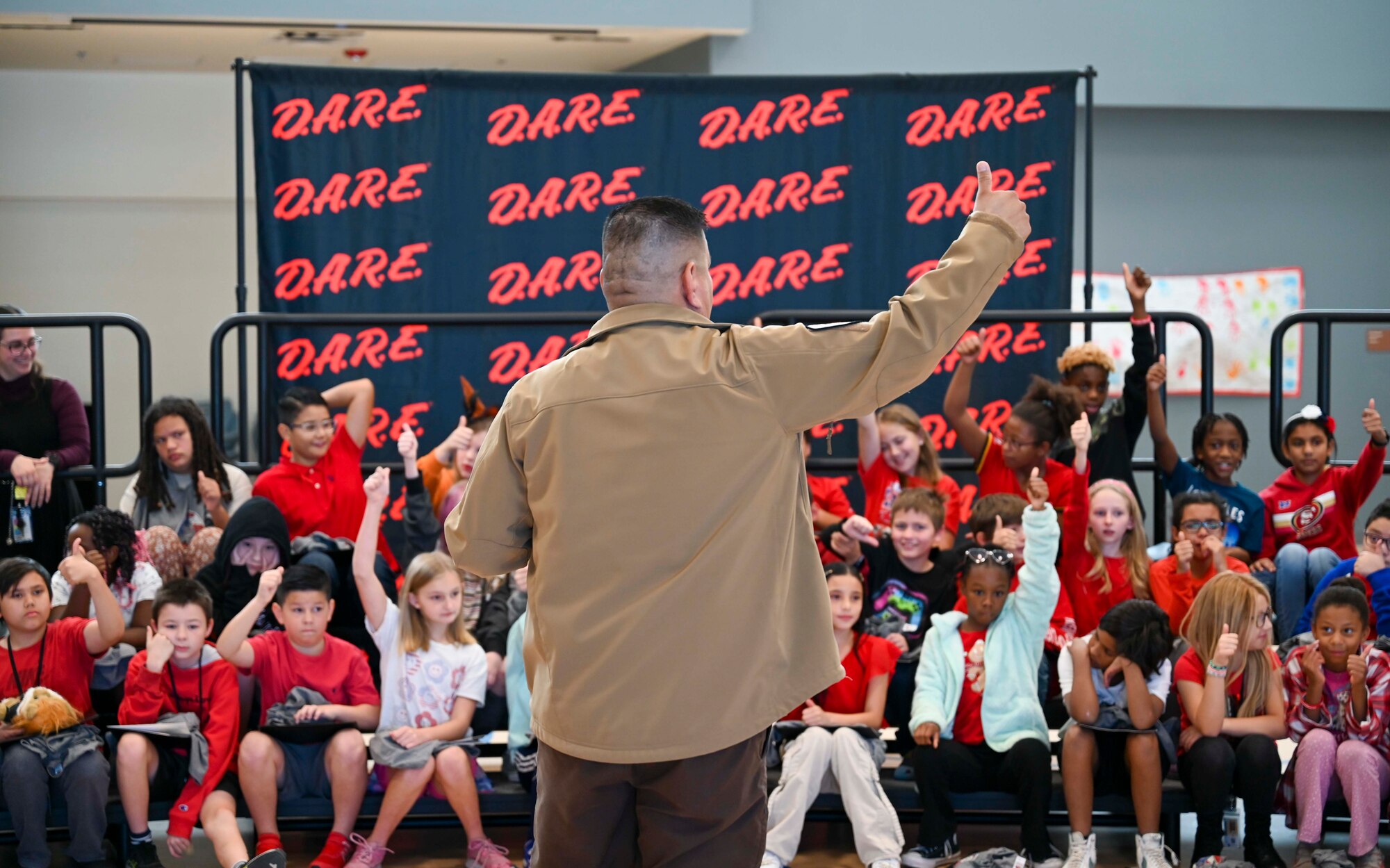 Raul Robles, Otero County public relations deputy sheriff, gives closing remarks during a Drug Abuse Resistance Education graduation to students at Holloman Air Force Base, New Mexico, Oct. 31, 2024. The D.A.R.E. program is funded by donations and taught by local law enforcement agencies, providing children with valuable insights that help them make positive choices in various situations by focusing on a culturally diverse curriculum that is suitable for various developmental stages. (U.S. Air Force photo by Airman 1st Class Michelle Ferrari)