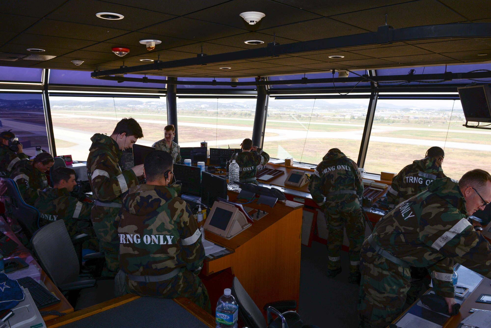 Airmen assigned to the 51st Operations Support Squadron prepare to don their M-50 gas mask during Beverly Herd 25-1 at Osan Air Base, Republic of Korea, Oct. 29, 2024. During the exercise, base personnel demonstrated their ability to navigate various attack scenarios while launching and recovering aircraft during 24-hour flying operations, validating the 51st Fighter Wing’s readiness and response against any adversary. (U.S. Air Force photo by Staff Sgt. Kahdija Slaughter)